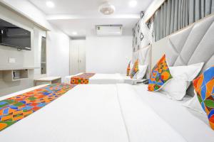 a bedroom with two beds in a room at FabHotel Grey Sky in Gandhinagar