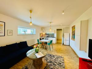 a living room with a couch and a table at Design Apartments in Ostrów Wielkopolski