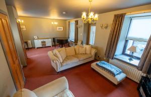 a living room with a couch and a table at Rockvale Cottage in Fort William
