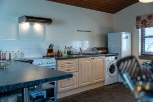 a kitchen with a refrigerator and a sink and a dishwasher at Rockvale Cottage in Fort William +17 photos