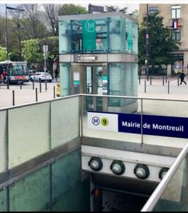 a building with a sign in front of a street at Beau studio haut standing de 30m2 in Montreuil
