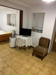 a living room with a table and a chair at Traditional House with breathtaking view, Makis in Sívros