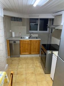 a small kitchen with a sink and a stove at Traditional House with breathtaking view, Makis in Sívros +11 photos