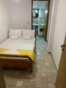 a bedroom with a bed with a yellow blanket on it at Traditional House with breathtaking view, Makis in Sívros