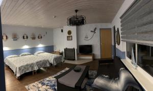 a bedroom with two beds and a flat screen tv at Apartments Weintrauben in Pärnu