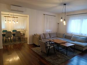 a living room with a couch and a table at Urban Home in Sarajevo
