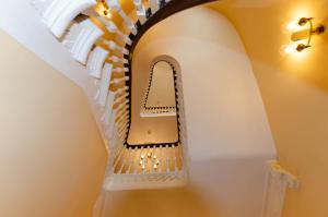 a staircase in a house with a spiral stair case at Opul Boutique at Admiral House in Douglas
