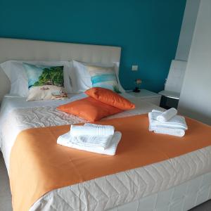 a large bed with two towels on top of it at Dimora Kalypso in Polignano a Mare