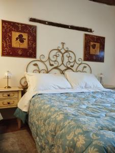 a bedroom with a large bed and a night stand at Agriturismo Casa Rastelli in Monteorsello