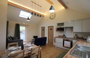 a kitchen and a living room with a table and a dining room at Bridge House in Haltwhistle