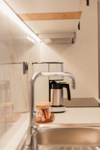 a coffee maker sitting on a counter in a kitchen at DK APARTMENTS in Ioannina