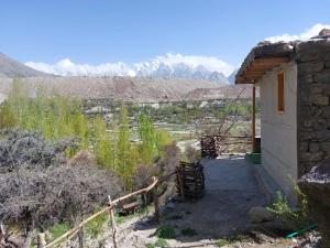 a small building with mountains in the background at Kungrah Resort in Chamangul