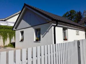 a white house with windows and a white fence at Chata u Myšáka in Maxov
