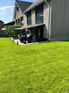 a house with a lawn in front of it at Ferienhausträume Oase Bodensee in Kreuzlingen