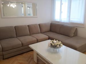 a living room with a couch and a table at Luxury Apartment Centar Mostar in Mostar