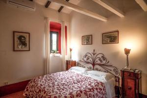 a bedroom with a red and white bed and a window at Proprietà Scalfati in Sabaudia