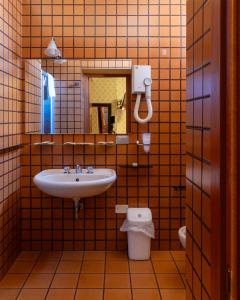 a bathroom with a sink and a toilet at Hotel Terme in Sarnano