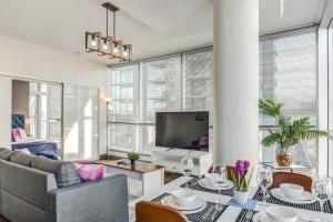 a living room with a couch and a table at Luxury 2BR Condo - Downtown City Views in Calgary