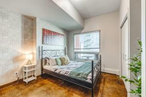 a bedroom with a bed and a window at Luxury 2BR Condo - Downtown City Views in Calgary