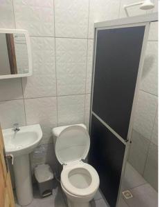 a small bathroom with a toilet and a sink at Hotel PALLACE in Belém