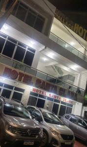 a parking lot with cars parked in front of a hotel at Hotel PALLACE in Belém +7 photos