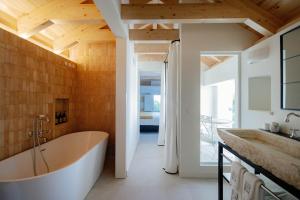 a bathroom with a tub and a sink at La Fonda Heritage Hotel Luxury, Relais & Châteaux in Marbella +59 photos