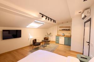 a room with a bed and a table and a kitchen at Evra Suites Hotel in Istanbul