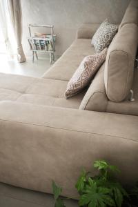 a couch sitting in a living room next to a window at Casa Patty vista Portofino in Zoagli