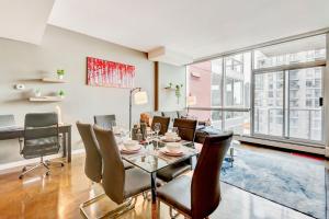 a dining room with a table and chairs at Modern 2BR Condo - King Bed - Downtown City Views in Calgary