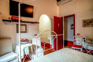a bedroom with a bunk bed and a room with a table at Proprietà Scalfati in Sabaudia