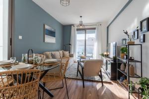 a dining room and living room with a table and chairs at Moon Light 1-Bedroom Apartment in Larnaca in Larnaka