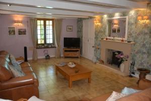 a living room with a couch and a fireplace at Large 3 bedroom Cottage near Ruffec in Bernac
