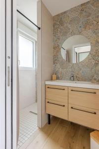 a bathroom with a sink and a mirror at Ar Mor, votre pied à terre cocoon au cœur de ville in Paimpol +42 photos