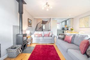 a living room with a couch and a stove at Number One in Chapel Stile