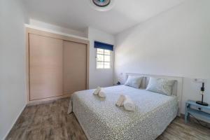 ein Schlafzimmer mit einem Bett mit zwei Handtüchern darauf in der Unterkunft Sol y mar maspalomas in Maspalomas