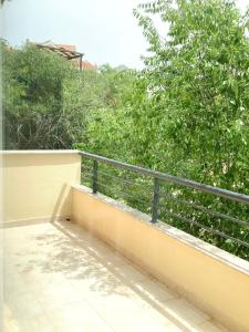 balcón con barandilla y árboles en el fondo en Apartments Dante Domus Aurea, en Milna