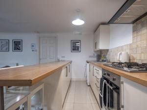a kitchen with white cabinets and a counter top at Spacious City Sanctuary in Newcastle upon Tyne +8 photos