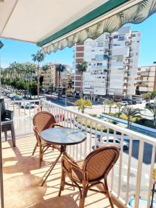 a patio with two chairs and a table on a balcony at New Apartment Alejandro in Torre del Mar