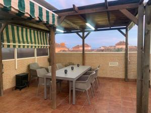 a table and chairs on a patio with a view at Vivienda en Costa Narejos in Los Alcázares