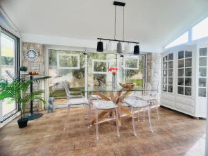 a dining room with a glass table and chairs at Villa Sunshine in Pula