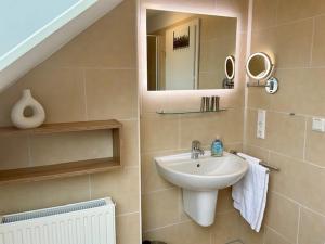 a bathroom with a sink and a mirror at Grachtenkate in Greetsiel +51 photos