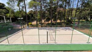 a tennis court with a net on a court at Atibaia Residence Hotel & Resort in Atibaia