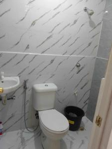 ein Badezimmer mit einem weißen WC und einem Waschbecken in der Unterkunft TMD COMFORTABLE TRANSIENT HOUSE IN STO.TOMAS BATANGAS in San Felix