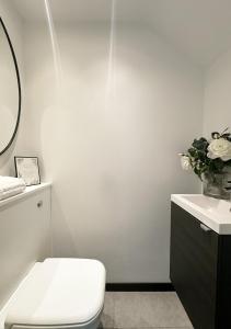 a bathroom with a toilet and a sink at The Barn in Chichester