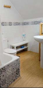 a bathroom with two toilets and a sink at Apartamentos home Chipiona in Chipiona