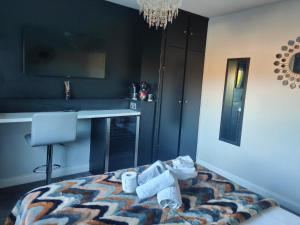 a bedroom with a bed with towels and a desk at City Centre Room in Chester