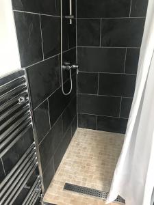 a bathroom with a shower with a shower curtain at City Centre Room in Chester
