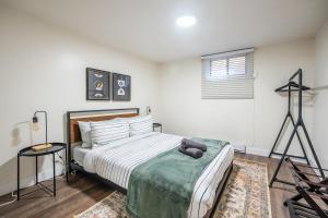 a bedroom with a bed and a tripod in it at Modern 2BR Queen Beds - Close to Bellwoods Park in Toronto
