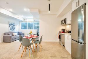 a kitchen and living room with a table and chairs at Stylish 2BR Condo in Proximity to City Center in Toronto
