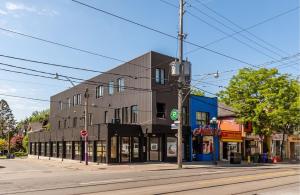 a building on the corner of a street at Spacious 2BR Apartment - Minutes to Leslieville in Toronto